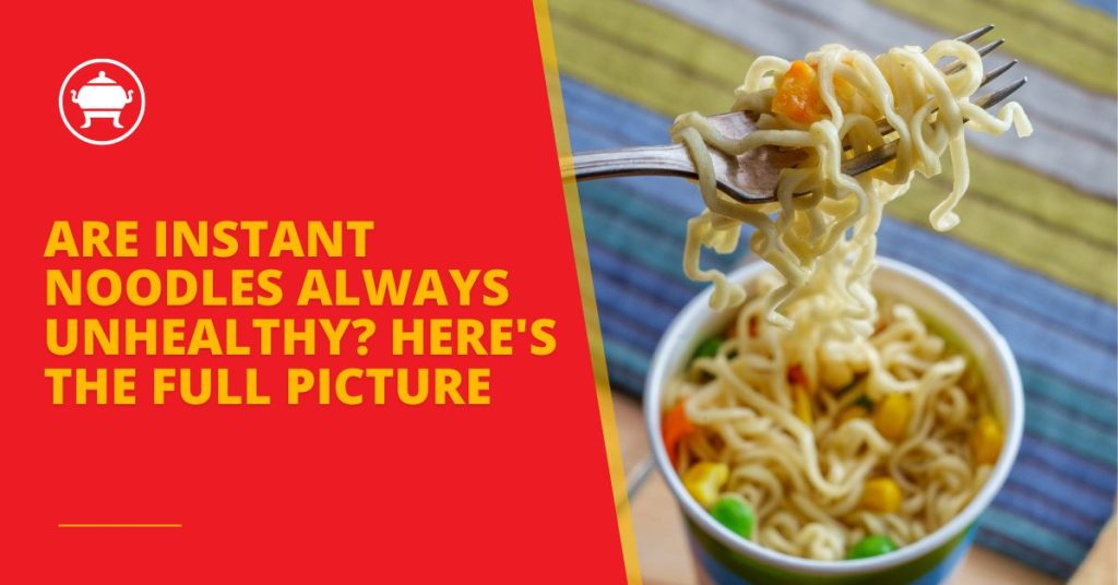 Cup of instant noodles with mixed vegetables, with a fork lifting a bite-sized portion, set against a colorful striped background.